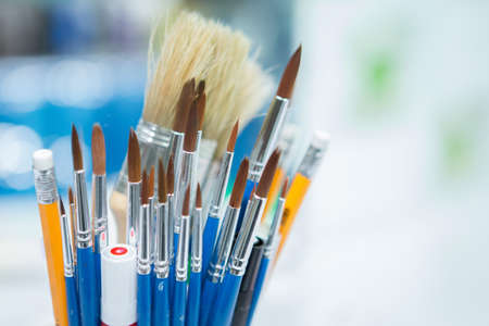 Selective focus of Many brushes and art supplies on blurred backgroundの写真素材