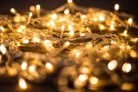 Close up of beautiful LED warm lights on wooden floor background