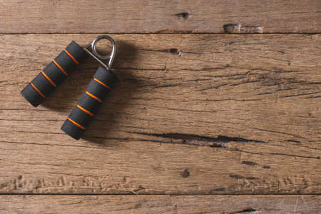Top view of Hand grip for finger exercise on the wooden table and copy spaceの写真素材