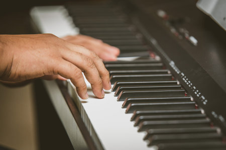 Selective focus of Man hand playing piano
