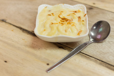 Au Gratin in a white bowl on a wooden table