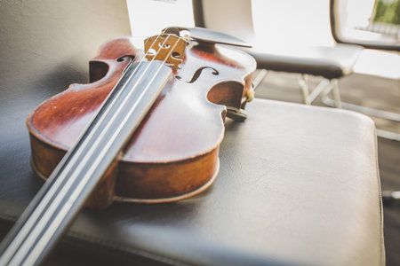 Selective focus of Violin on musician chair
