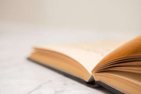 Close up of Old books opened on the reading tableの写真素材