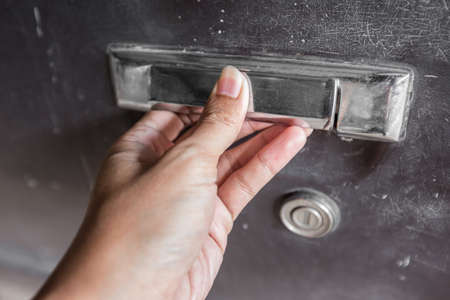 Close up of Hand on Old car door handleの写真素材