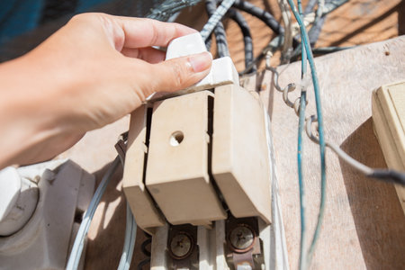 Hand is holding the old breaker switch