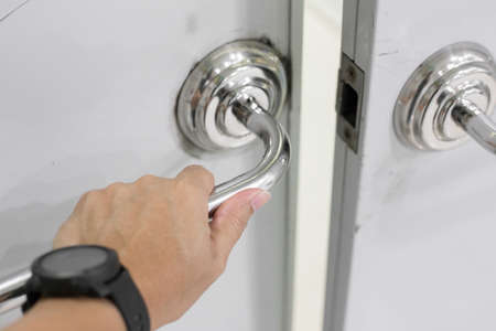 Selective focus of Hand on Stainless Steel Door Handlesの写真素材