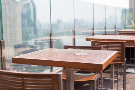 Ashtray on the wooden table at an outdoor cafeの写真素材