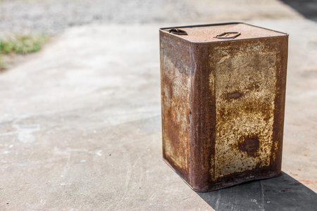 Rusted steel bucket on concrete floorの写真素材