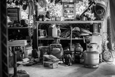 Black and white of Many equipment in dirty workshopの写真素材