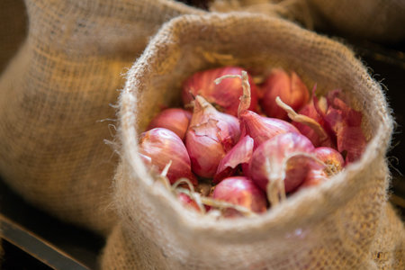 Close up of Shallot in cloth sacks on blurred background