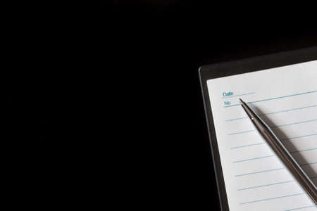 Top view of Pen, notebook on black background and copy spaceの写真素材