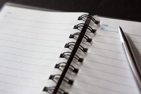 Selective focus of Pen, notebook, on black background and copy space
