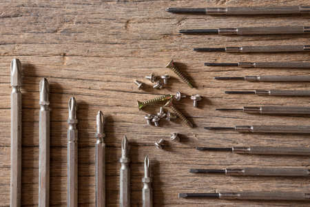 Top view of Many sizes screwdriver and screw nut on the wood background and copy spaceの写真素材
