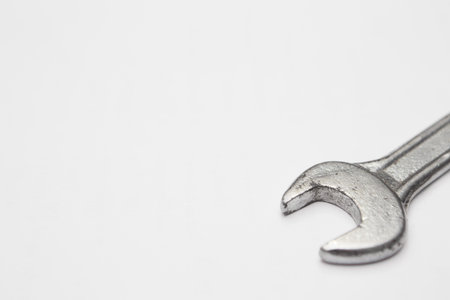 Steel wrench on white background