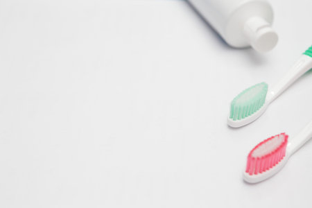 Toothbrush and toothpaste tube on a white background