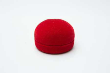 Gold ring in red ring box on white background