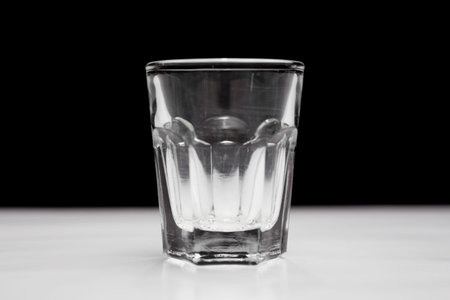 Shot glass on white and black background