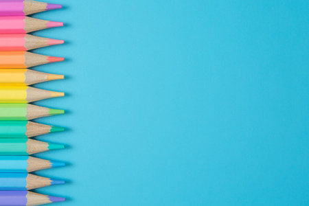 Colorful Pattern of Pastel colored pencils on blue background and copy space