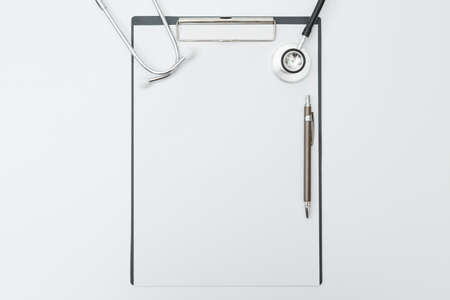 Top view of Stethoscope, Document Board, Pen on white background and copy spaceの写真素材