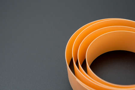 Spiral cream ribbon on a black background and copy spaceの写真素材