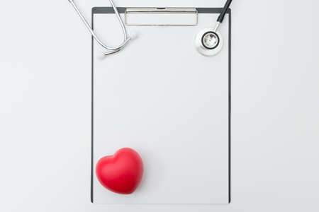 Top view of Stethoscope, Document Board, Pen, Heart shaped ball on white background and copy spaceの写真素材