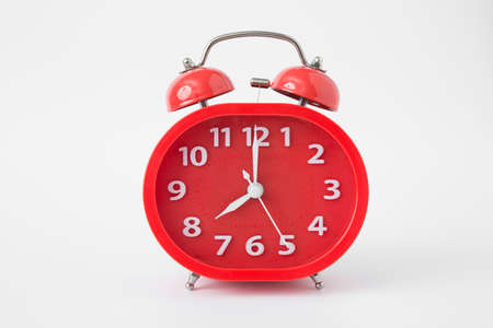 red alarm clock on a white backgroundの写真素材