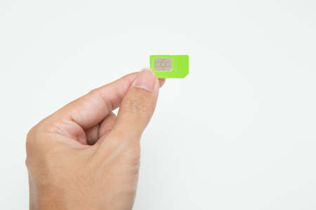Hand holding SIM card on white backgroundの写真素材