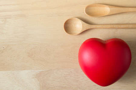 Top view of Wooden scoop, Heart shaped ball on wood background and copy spaceの写真素材