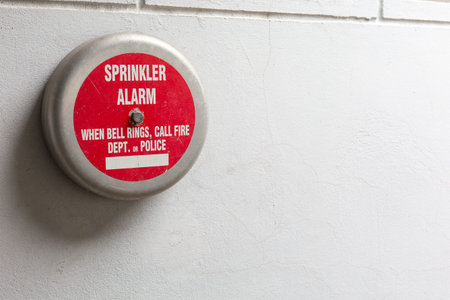 Old Fire alarm on the white wall