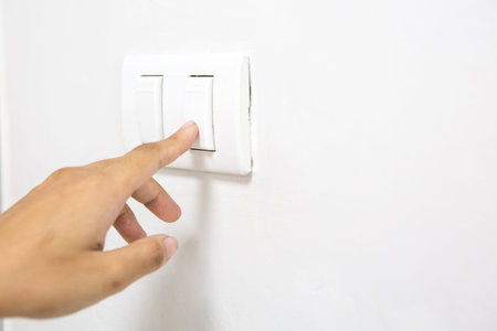 A woman's finger is pressing a switch and copy space