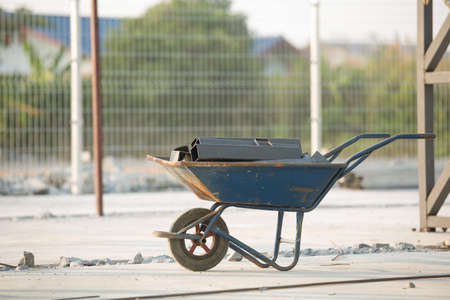 Steel pile on construction trolley in construction siteの写真素材