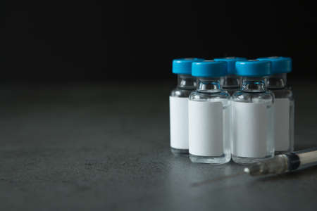 Selective focus of Many vaccine bottles and syringes on concrete background for the virus concept and copy spaceの写真素材