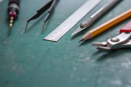 Selective focus of Many DIY equipment on a green cutting mat and copy space for do it yourself conceptの写真素材