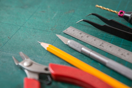Selective focus of Many DIY equipment on a green cutting mat and copy space for do it yourself...