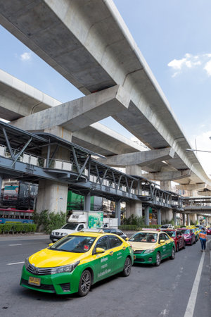 Bangkok Thailand , May 18 , 2021 : The popular BTS mass transit system for people and many taxis on the road of Bangkok, Thailandのeditorial素材