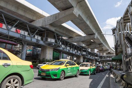 Bangkok Thailand , May 18 , 2021 : The popular BTS mass transit system for people and many taxis on the road of Bangkok, Thailandのeditorial素材
