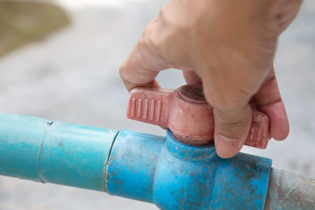 Hand holding to close the old and dirty faucet and copy space