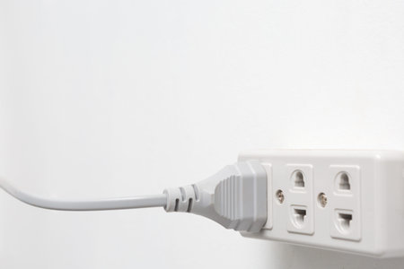 Power socket and electrical plug on white background and copy space