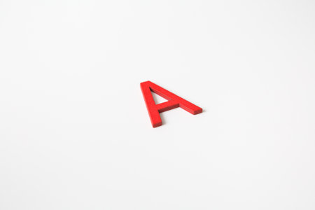 Red wooden english letters "A" on white background and copy space for educational and graphic conceptの写真素材