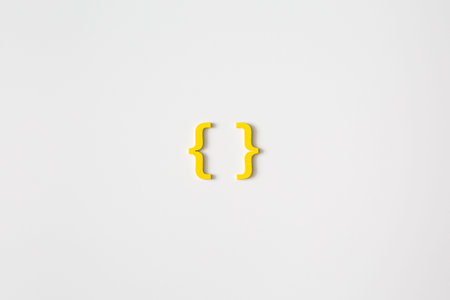 Yellow wooden symbol bracket on white background and copy space for social media educational concept