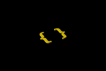 Yellow wooden symbol "bracket" on black background and copy space for social media educational conceptの写真素材