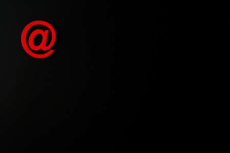 Red wooden symbol "at" on black background and copy space for social media educational conceptの写真素材