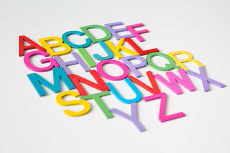 Colorful wooden english letters A-Z on white background and copy space for educational and graphic conceptの写真素材