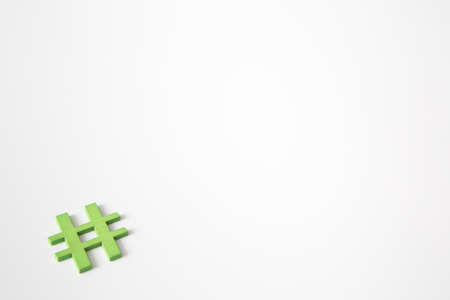 Green wooden symbol Hashtag "#" on white background and copy space for social media educational conceptの写真素材