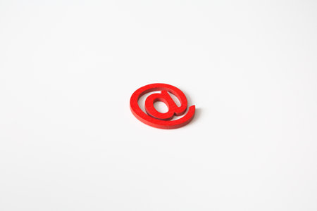 Red wooden symbol "at" on white background and copy space for social media educational conceptの写真素材