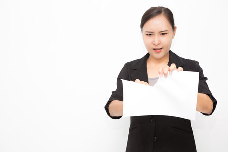 Beautiful Asian business woman wearing black suit. Angry woman tearing up documents and stress  on...