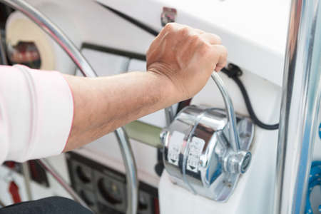 Man driving a boat. Man's hand controlling the accelerator of a boat.の写真素材