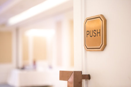 Selective focus of Push sign on the white door of the seminar room.の写真素材