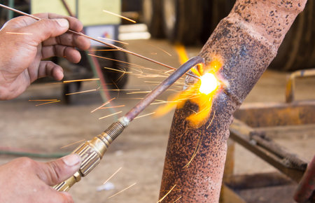 A welder at work, sparks in the air