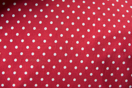 white polka dot in red background texture on cover pillowの写真素材